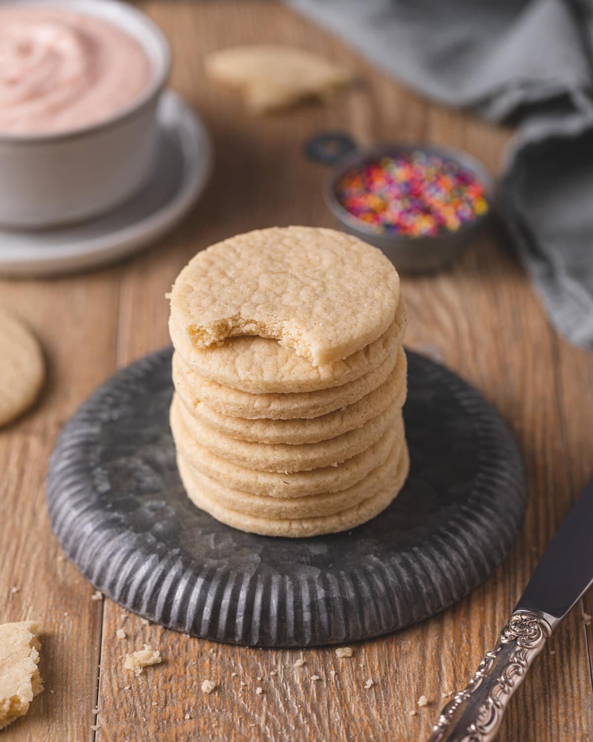 Stack of sugar cookies on an overturned metal plate.